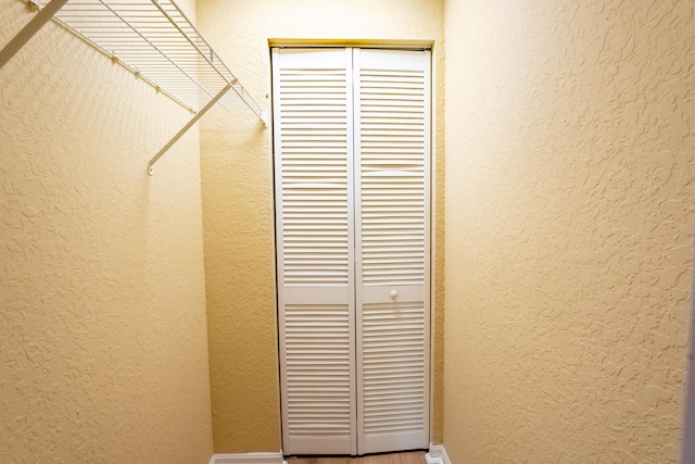 details with a textured wall and baseboards