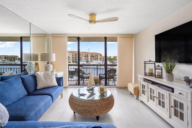 living room featuring a wealth of natural light, a wall of windows, and ceiling fan