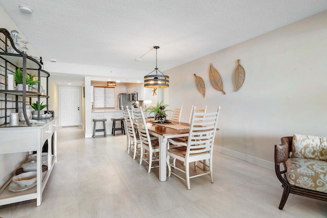 dining space featuring a textured ceiling