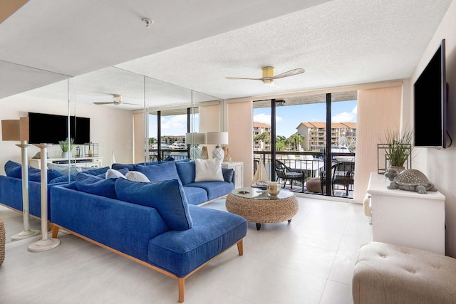 living room featuring a textured ceiling, floor to ceiling windows, and ceiling fan