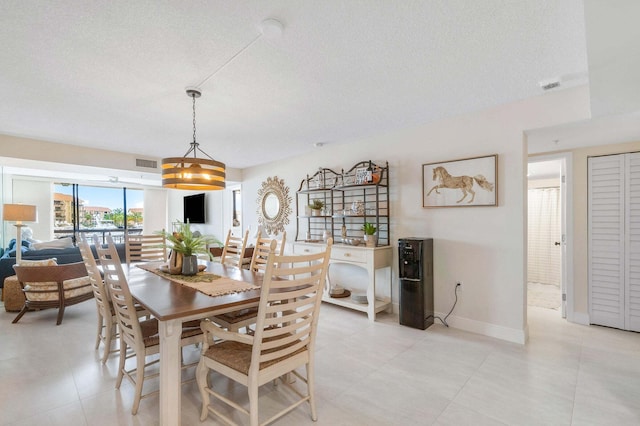 dining space with a textured ceiling