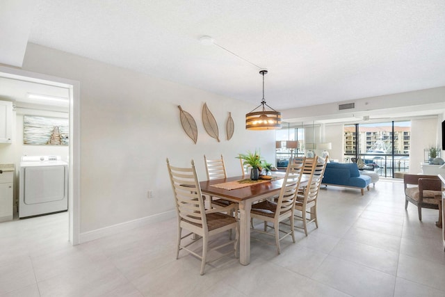 dining room with washer / clothes dryer and a textured ceiling