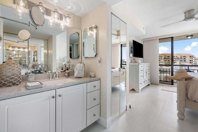 bathroom with expansive windows, vanity, and a textured ceiling