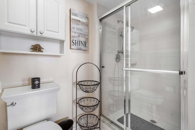 bathroom featuring toilet and walk in shower