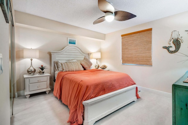 bedroom featuring a textured ceiling and ceiling fan