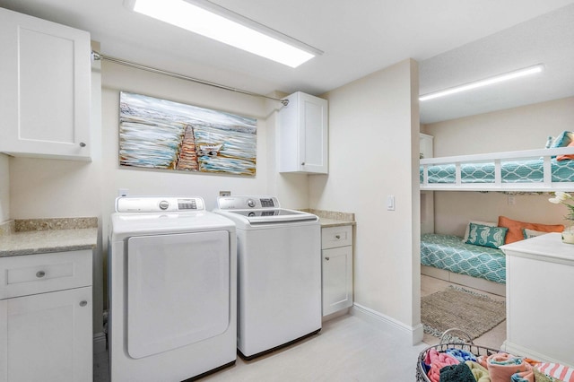 washroom featuring independent washer and dryer and cabinets