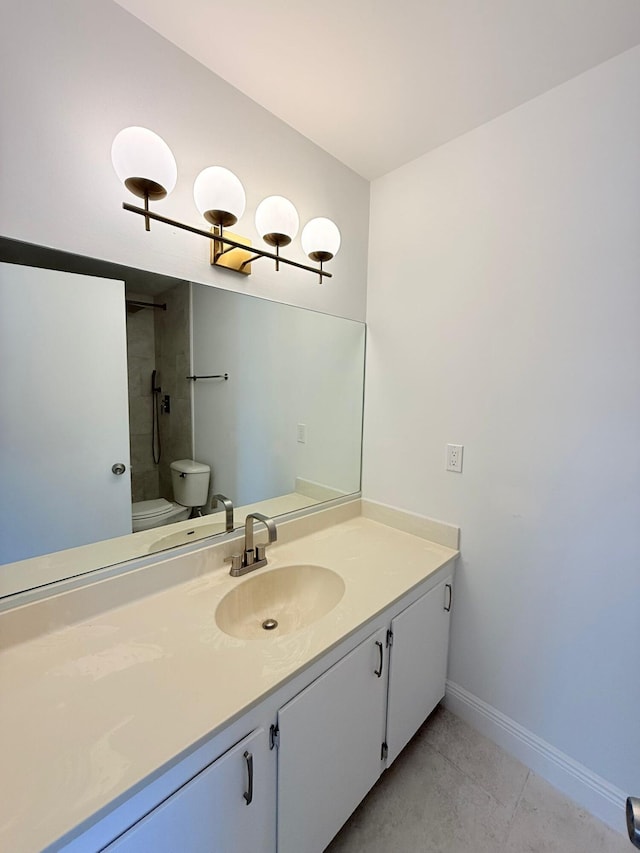 bathroom featuring vanity, tile patterned floors, toilet, and tiled shower