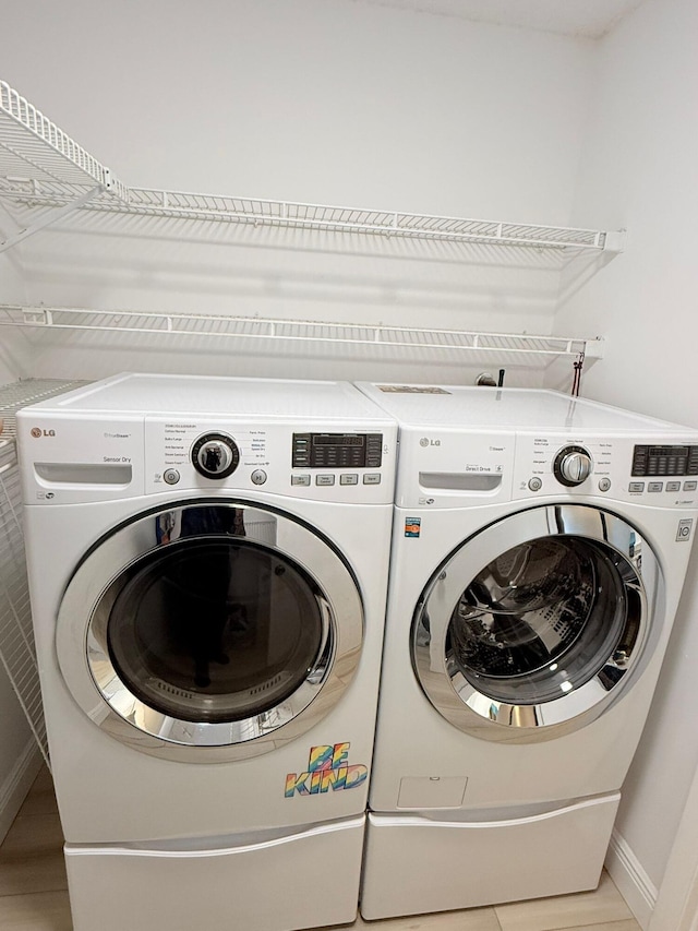 laundry area featuring washing machine and clothes dryer