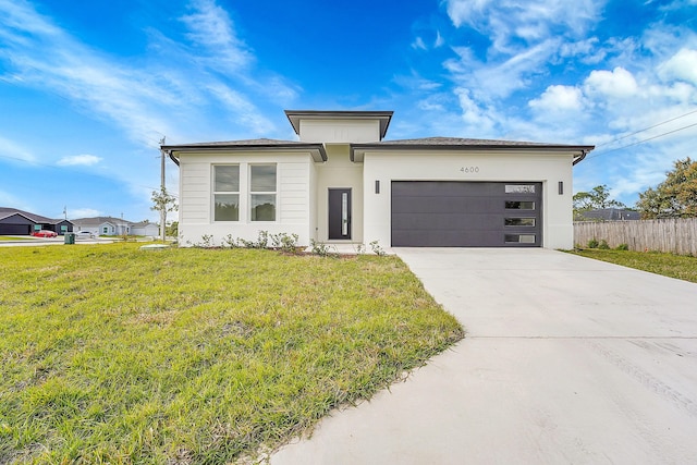 view of front of home featuring a garage and a front lawn