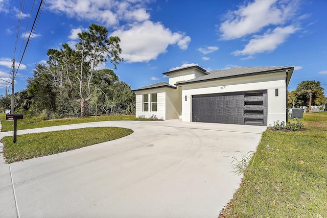 prairie-style home with a garage, central AC, and a front lawn