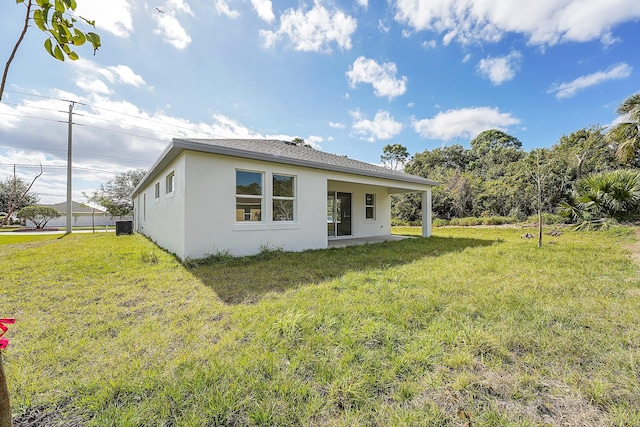 rear view of property featuring a lawn