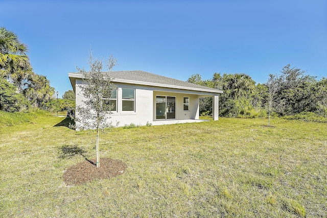 back of house featuring a patio and a lawn