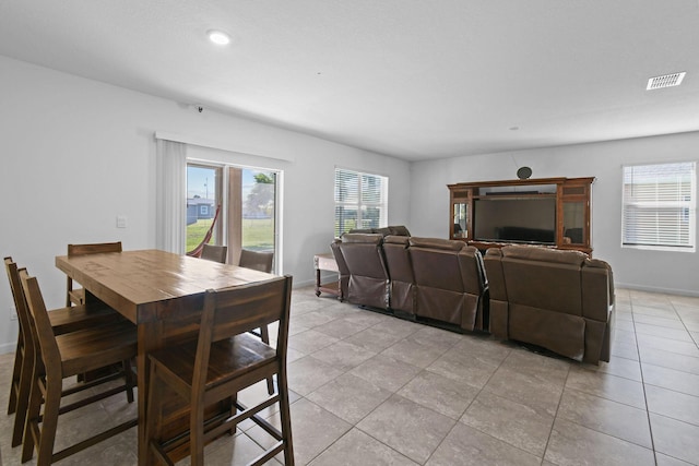 dining space featuring a healthy amount of sunlight, baseboards, and visible vents