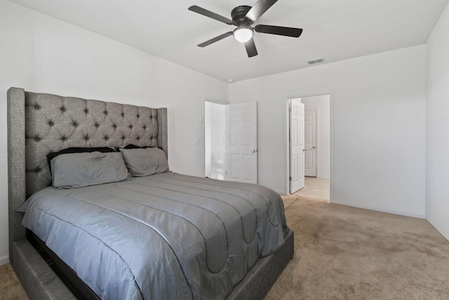 bedroom featuring visible vents, a ceiling fan, and light colored carpet