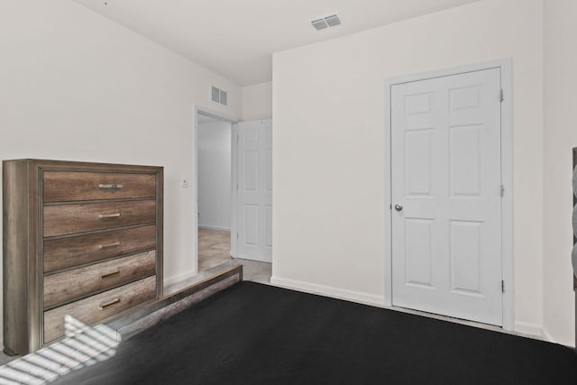 unfurnished bedroom featuring carpet, visible vents, and baseboards