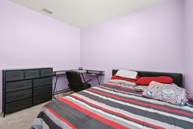 carpeted bedroom featuring visible vents