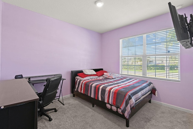 bedroom with carpet and baseboards