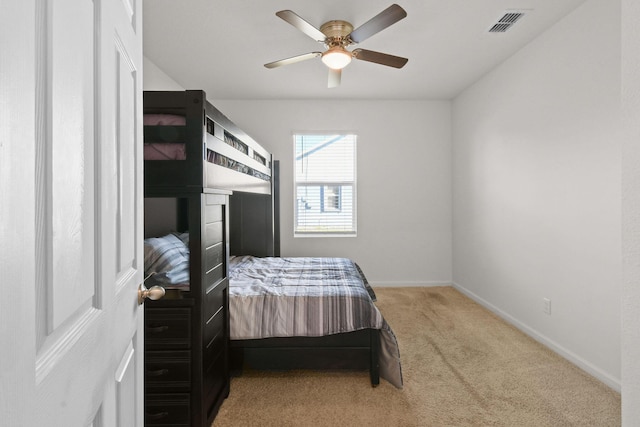 carpeted bedroom featuring visible vents, ceiling fan, and baseboards