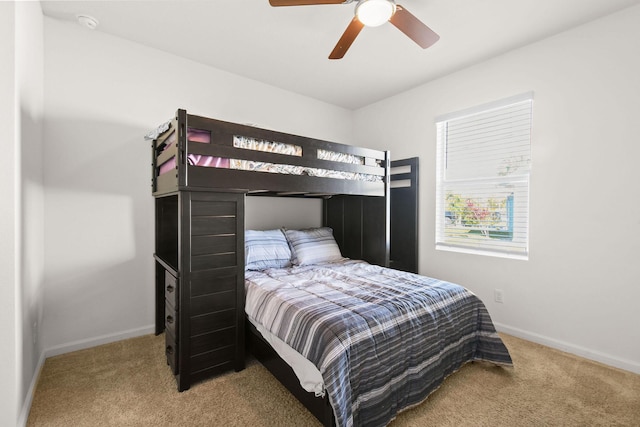 bedroom with carpet, ceiling fan, and baseboards