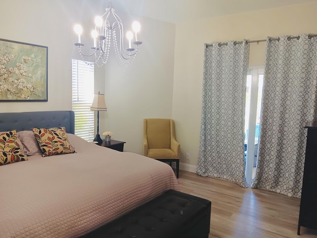 bedroom featuring hardwood / wood-style flooring and a notable chandelier