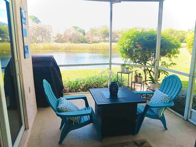 sunroom / solarium with a water view