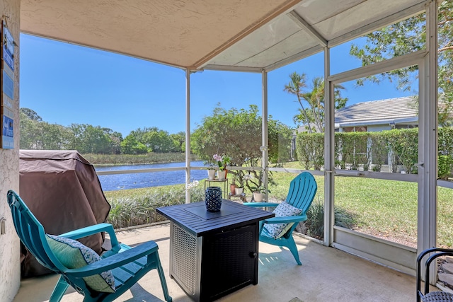 exterior space featuring stucco siding, a yard, and a water view