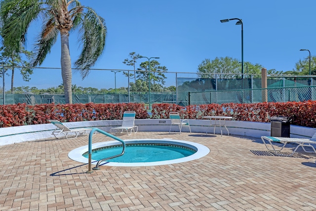view of pool with a patio area and fence