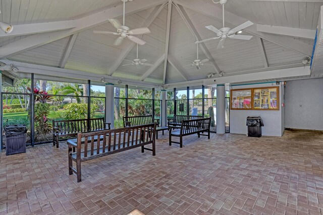 sunroom / solarium featuring beamed ceiling and a ceiling fan