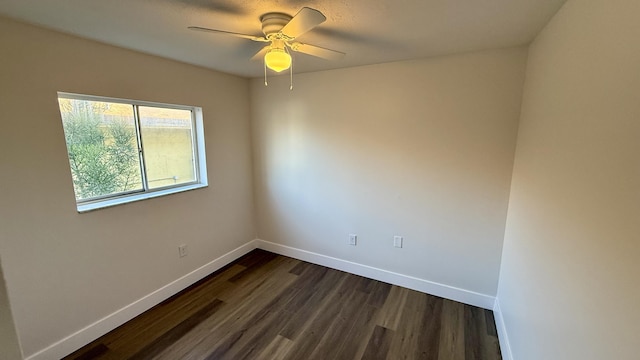 spare room featuring ceiling fan and dark hardwood / wood-style floors