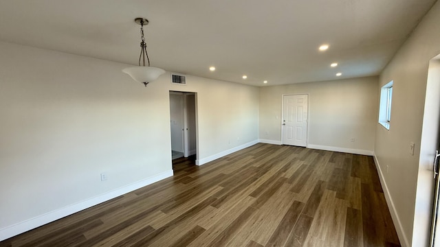 empty room with dark hardwood / wood-style floors