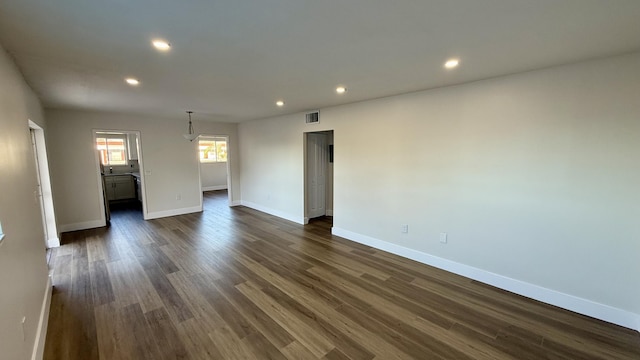 spare room with dark wood-type flooring