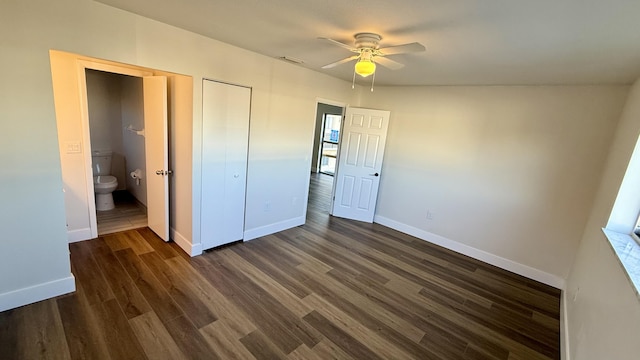 unfurnished bedroom featuring dark wood-type flooring, ceiling fan, and ensuite bathroom