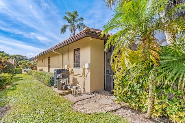 view of home's exterior with a yard