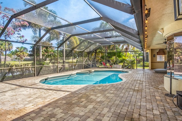 view of pool featuring a water view, a lanai, and a patio area