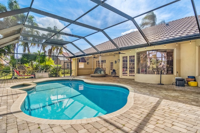 view of swimming pool featuring a patio, a lanai, french doors, and ceiling fan