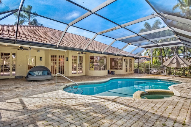 view of pool featuring french doors, glass enclosure, an in ground hot tub, ceiling fan, and a patio