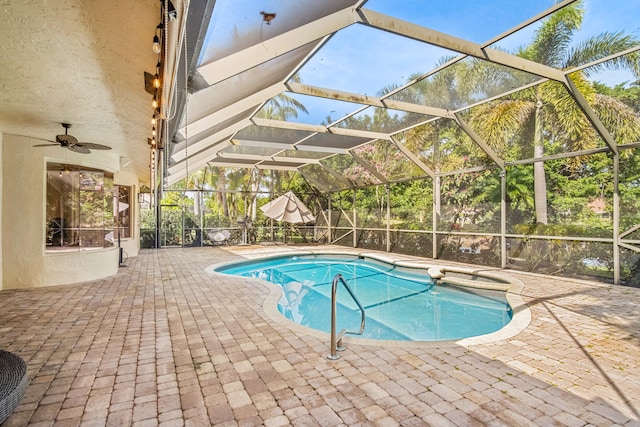 view of pool with ceiling fan, a lanai, and a patio area