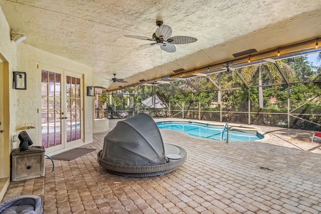 view of pool featuring a patio, a lanai, ceiling fan, and french doors