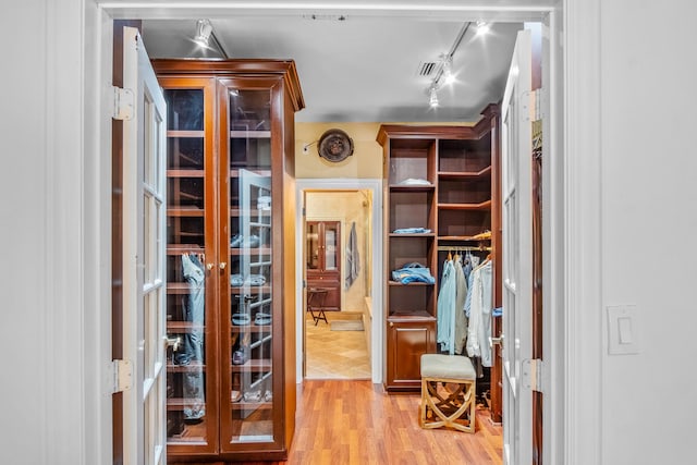 walk in closet featuring light hardwood / wood-style flooring