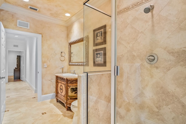 bathroom featuring crown molding, vanity, toilet, and an enclosed shower