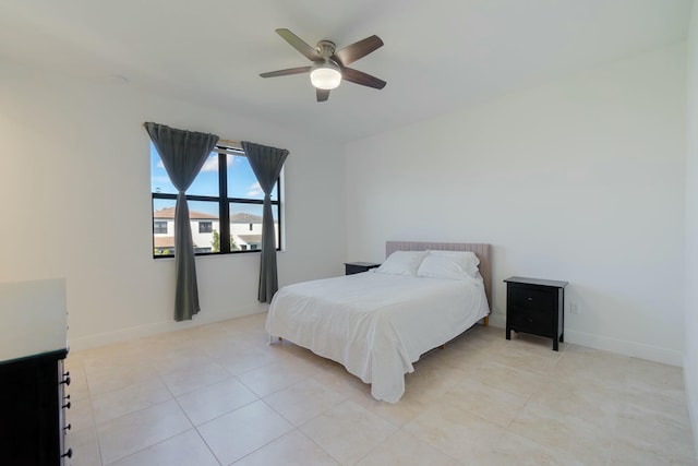 bedroom featuring light tile patterned floors and ceiling fan