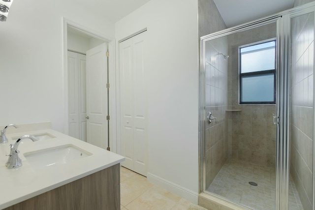 bathroom with vanity, tile patterned flooring, and a shower with door