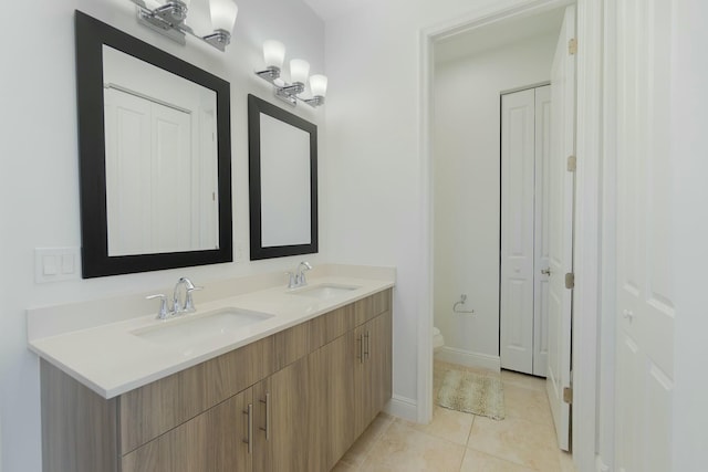 bathroom featuring tile patterned floors, toilet, and vanity