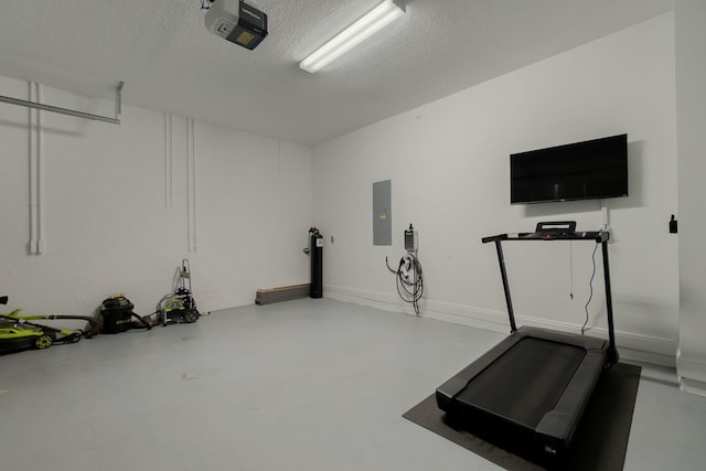 exercise area with electric panel and a textured ceiling