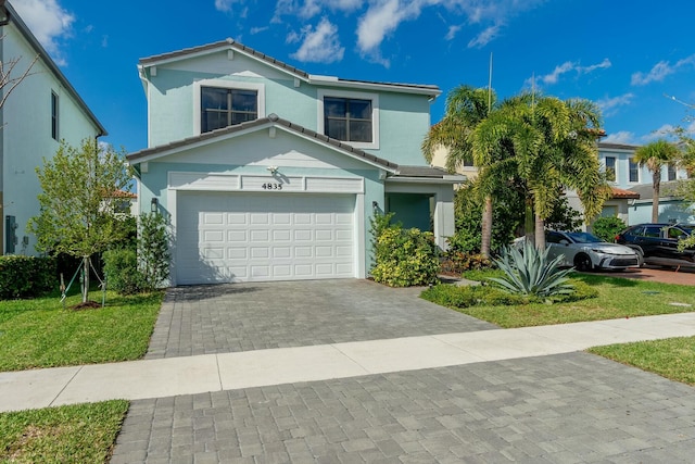 traditional home with a garage, decorative driveway, a tiled roof, and stucco siding