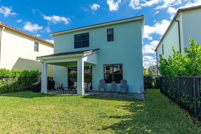 back of property featuring a yard and a patio