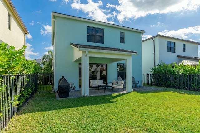 back of house featuring an outdoor living space, a patio area, and a lawn