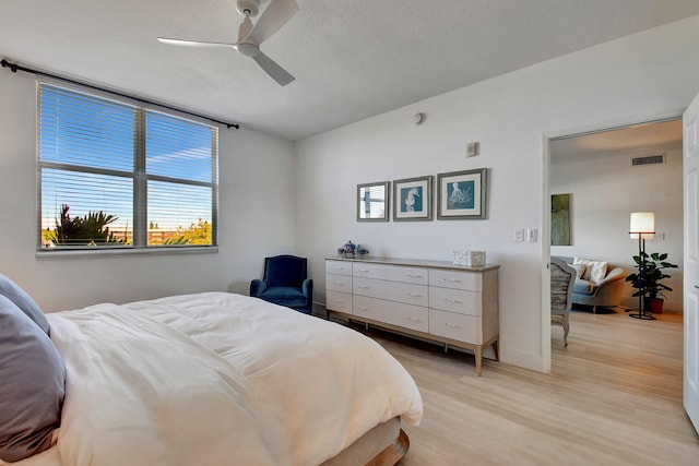 bedroom with ceiling fan and light hardwood / wood-style floors