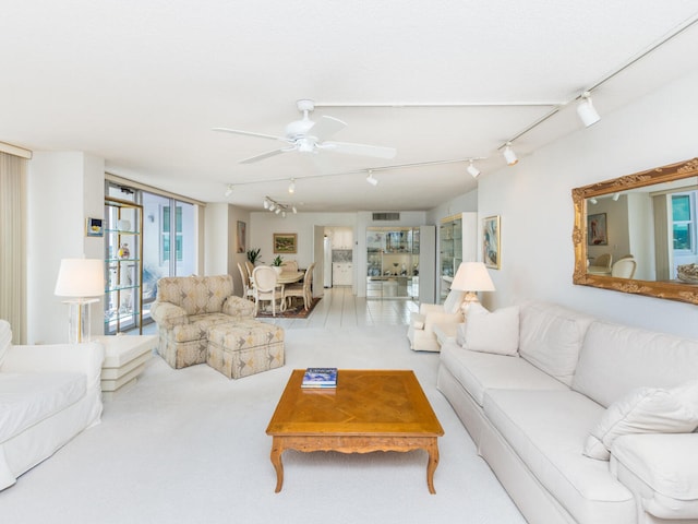 carpeted living room featuring ceiling fan