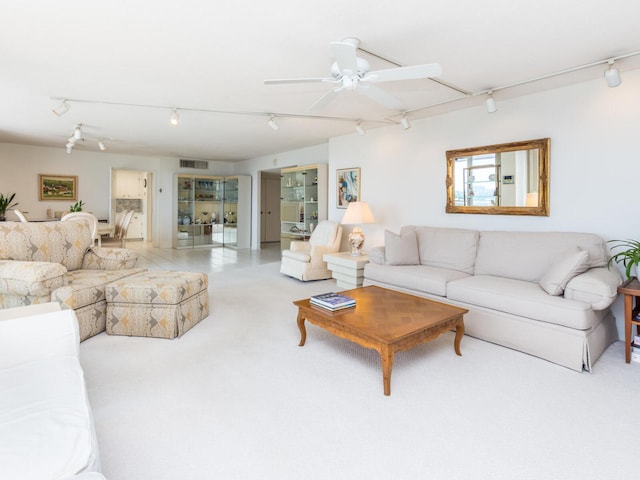 living room featuring light carpet and ceiling fan